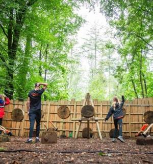 a group of people standing in front of a fence