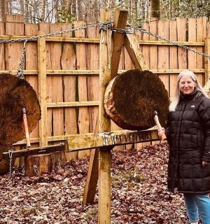 a group of people standing in front of a wooden fence