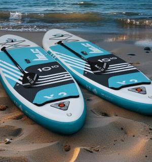 two surfboards sitting on the sand on the beach