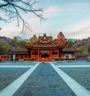 a temple in a park with a pathway leading to it