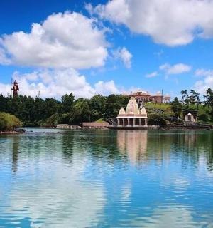 a large lake with a building in the middle of it