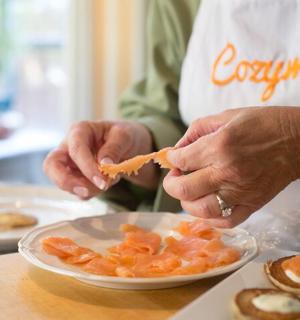 a woman is preparing a plate of food