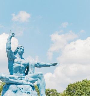 a statue of two people sitting on a rock