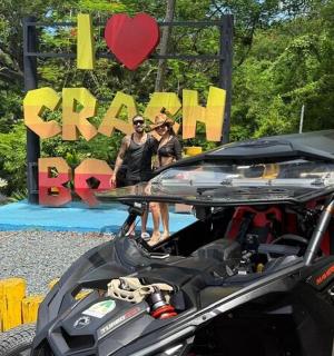 two women standing in front of a sign with a heart