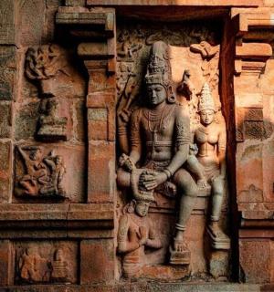 a stone statue on the side of a building