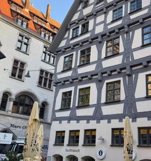 two white buildings with umbrellas in front of them