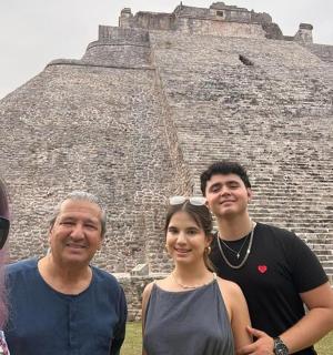 a group of people standing in front of a pyramid
