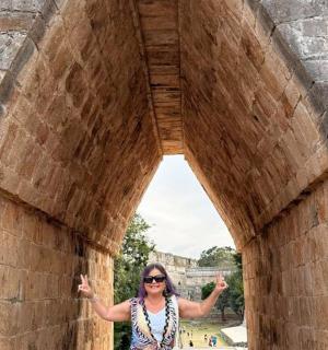 a woman standing in an archway of a building