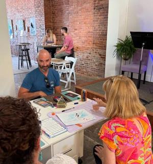 a group of people sitting around a table in a room