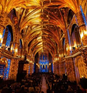 a large room with a large ceiling and people in it