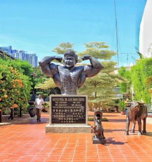 a statue of a man standing in a park