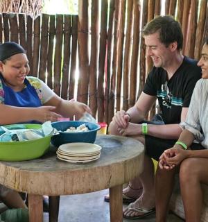 a group of three people sitting around a table