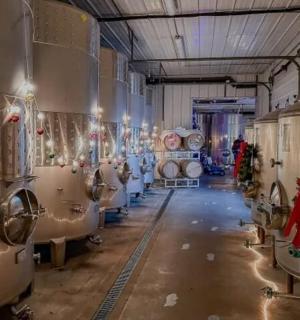 a wine cellar with christmas wreaths on the walls