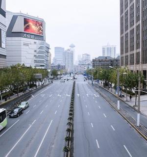a view of a city street with buses and cars