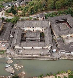 an aerial view of a building next to a river