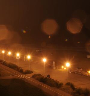 a parking lot with many street lights at night