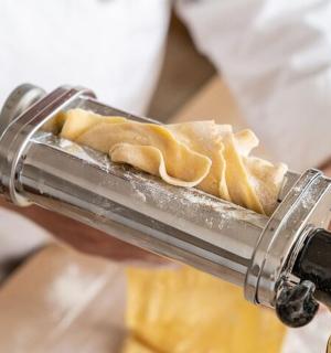 a person is holding a tray of food