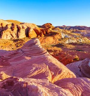 a view of the desert with eroded hills