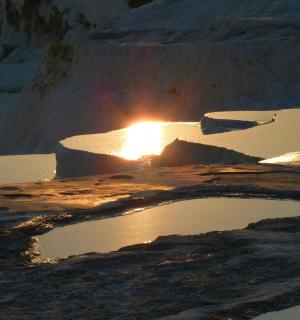 a fire pit with snow and water in it