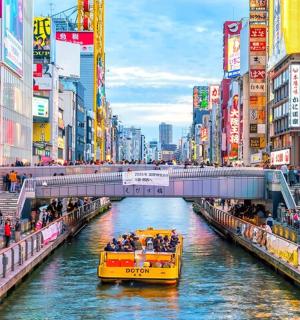 a yellow boat in a river in a city