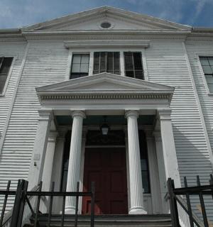 a large white house with a red door
