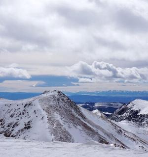 a snowy mountain range with snow covered mountains