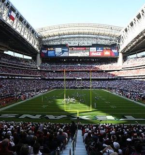 a crowd of people in a stadium watching a football game