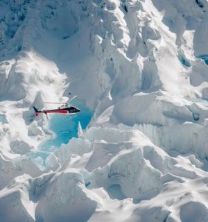 a plane flying over a snow covered mountain