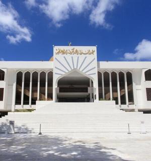 a large white building with stairs in front of it