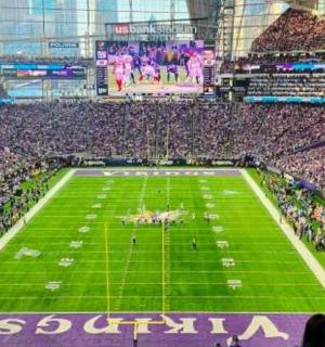 a football stadium filled with people watching a game