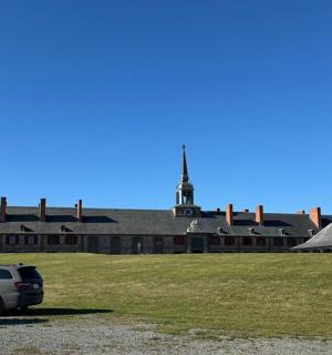 two cars parked in front of a large building