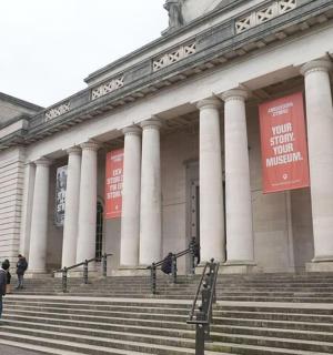 a large building with people walking in front of it