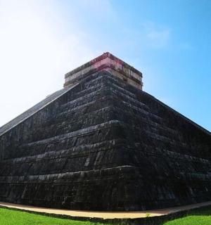 a large pyramid in the middle of a field