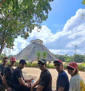 a group of people standing in front of the pyramid