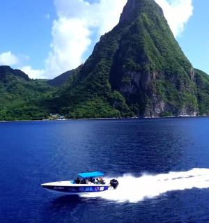 a boat in the water with a mountain in the background
