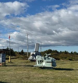 a boat sitting on the grass in a field