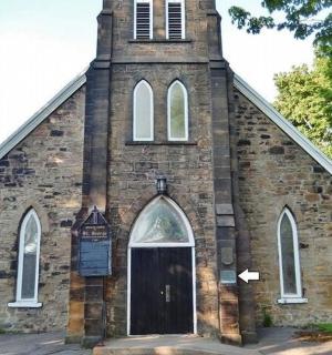 an old brick church with a clock tower