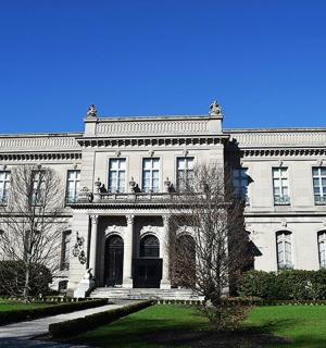 a large white house with a yard in front of it