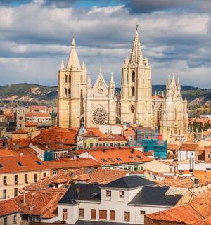 an aerial view of a city with churches and roofs