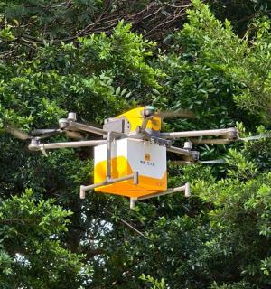 a yellow and white drone flying through a tree