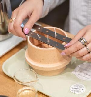a woman is making a planter on a table