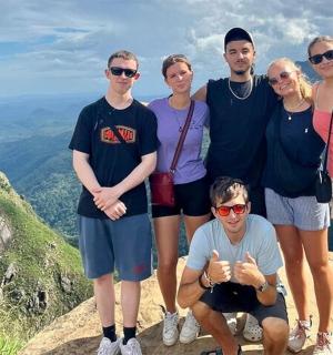 a group of people standing on top of a mountain