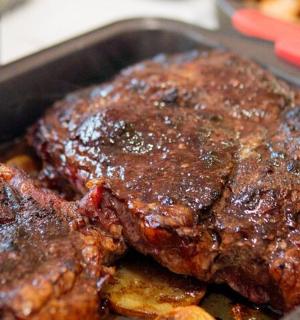 a pan with a piece of steak and french fries