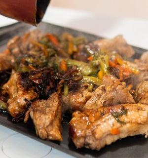 a plate of food with meat and vegetables