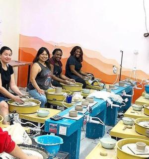 a group of people sitting around tables with bowls
