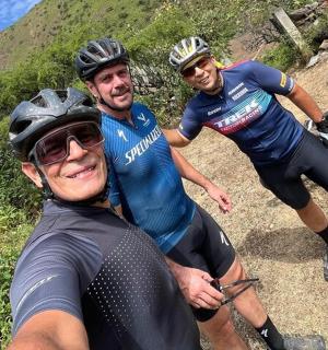 a group of three people on a mountain trail