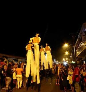 a group of people walking down a street with dresses