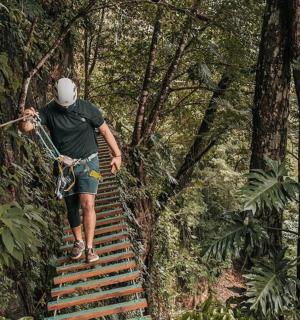 a man walking up stairs in the forest