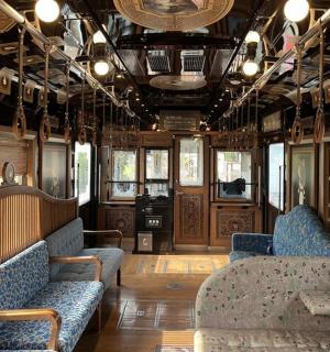 a train car with couches and chairs in a room