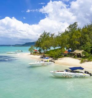 two boats in the water on a beach